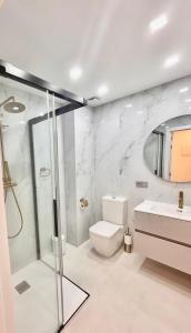 a bathroom with a shower and a toilet and a sink at Adeje Paradise in Adeje