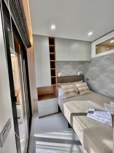 a small bedroom with two beds and a window at Adeje Paradise in Adeje