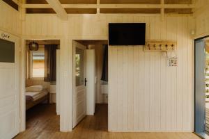 a room with a wall with a flat screen tv at Osada Chmiel in Chmielno +72 photos