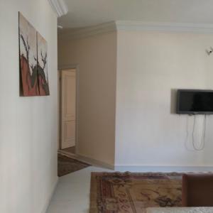 a room with a tv on the wall and a couch at العاصمة الإدارية in Cairo
