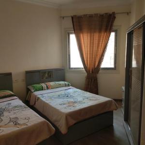 two beds in a room with two windows at العاصمة الإدارية in Cairo +9 photos