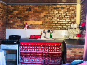 a kitchen with a sink with a red blanket on it at Hospedaje Maria Valentina in Tota