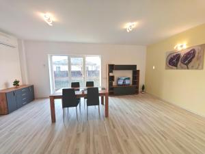an empty room with a dining room table and chairs at Vila Novara V25 in Bordeiu