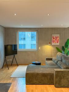 a bedroom with a large bed and a flat screen tv at Sunset Club - LOFT II - 160 m2 - Zentral in Memmingen
