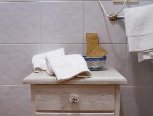a bathroom with a table with towels on it at Arca Hotel in Pienza +55 photos
