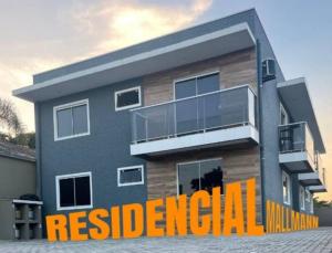 a house with a residential sign in front of it at Residencial Mallmann in Itapoa