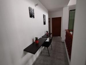 two tables and chairs in a room with a hallway at HOTEL LA FONTANA in Yopal