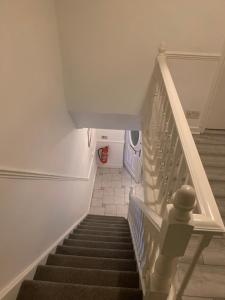 a staircase in a house with a stair case at AT Apex House S in Dagenham