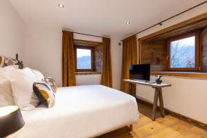 a bedroom with a bed and a desk with a computer at Wanderful Life MontBlanc refuge haut de gamme in Saint-Gervais-les-Bains
