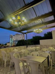 a group of tables and chairs under a roof at Hotel Los Maderos in Cali +21 photos
