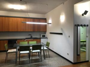 a kitchen with a table and chairs in a room at Guesthouse - Hotel California 2 in Zagreb