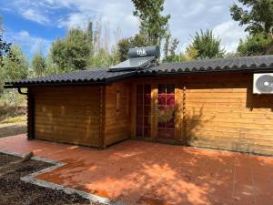 a log cabin with a patio in front of it at Quinta do Pinheiro in Ourém