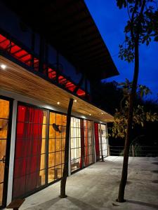 a building with stained glass windows and a tree at Miterio Mundo Nuevo in Minca