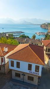 an aerial view of a building with a view of the ocean at Oldies Hotel in Antalya