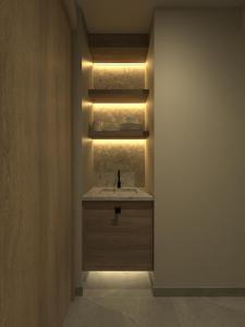 a bathroom with a sink with a light in it at King's Blue , Superior Living in Heraklio Town