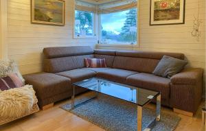 a living room with a couch and a coffee table at Beautiful Home In Skodje in Vatne +19 photos