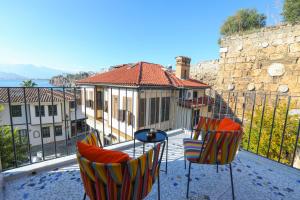 a balcony with two chairs and a table and a building at Oldies Hotel in Antalya