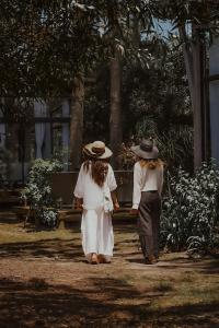 two women walking down a path in a park at Bella Bungalows in Punta Del Diablo