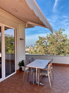 a table and chairs on a balcony with a view at Villa 35 in Tirana