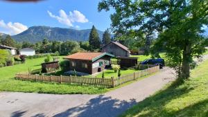 a house with a fence in front of a yard at Chalet Panorama Tirol in Hofen