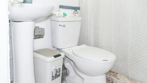 a bathroom with a white toilet and a sink at Estrella de Mar in Pedernales +21 photos