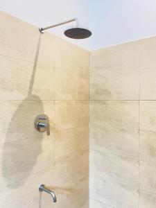 a shower with a shower head in a bathroom at Villa Minos in Hikkaduwa