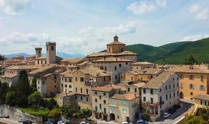 a group of buildings in a town with mountains at B&B Brunamonti in Arcevia