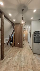 an empty room with a kitchen and a hallway at Forest Loft Apart in Alfeld