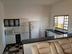 a kitchen with white appliances and a counter top at Rancho Costa in Pereira Barreto