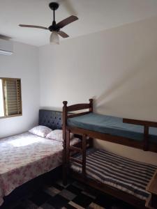 a bedroom with a bed and a ceiling fan at Rancho Costa in Pereira Barreto