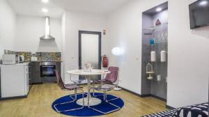 a kitchen with a table and chairs in a room at Cilio House in Ponta Delgada