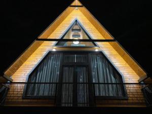 a building with a window with a light at Bungalov Aurora in Pale