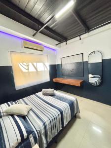 a bedroom with a bed and a mirror at Apto Moderno - Centro in Macapá