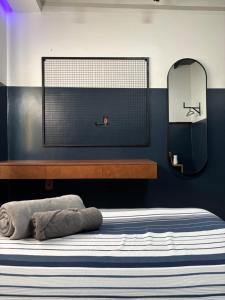 a bedroom with a bed with a mirror on the wall at Apto Moderno - Centro in Macapá