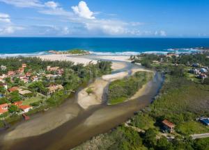 an aerial view of a beach and the ocean at Complexo Brisa Ferrugem in Garopaba