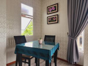 a dining room with a blue table and two chairs at Rainbow Residence in Phnom Penh