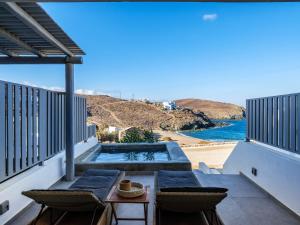 a view of the beach from the balcony of a house at Mykonos Residence Villas & Suites Merchia beach in Merchia Beach +290 photos