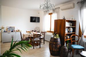 a living room with a table and a dining room at Villa Mafalda in Pietra Ligure