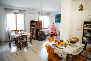 a living room with two tables and a christmas tree at Villa Mafalda in Pietra Ligure