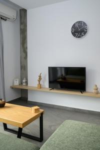 a living room with a tv and a coffee table at Modern Spacious Apartment in Kissamos