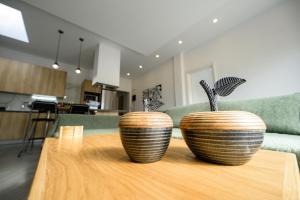 two vases sitting on top of a wooden table at Modern Spacious Apartment in Kissamos
