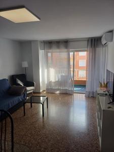 a living room with a couch and a table at City Centre apartments in Denia