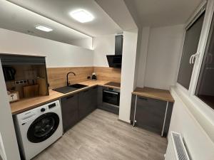 a kitchen with a washing machine and a washer at Apartment Zoe in Zell am See