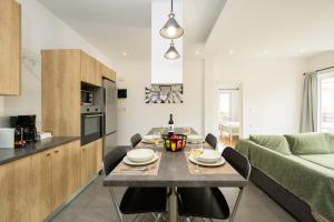 a kitchen and living room with a table and a couch at Modern Spacious Apartment in Kissamos +30 photos