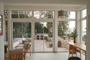 a dining room with sliding glass doors leading to a patio at Le Petit Croquant in Marseille