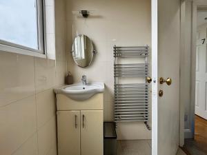 a bathroom with a sink and a mirror at Maberic Housing West London Gem Your Central London Connection in London +55 photos
