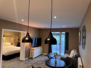 a bedroom with a bed and a living room at South Lawn Hotel in Lymington
