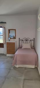 a bedroom with a bed and a dresser and a mirror at Casa de Andres in Casabermeja +20 photos