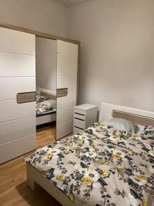 a bedroom with a bed and a dresser and a mirror at Motel Schwanen in Schlattingen