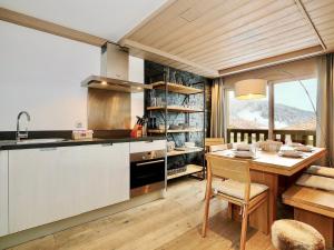 a kitchen with a table and a dining room at Appartement familial 3 chambres à Courchevel, parking et proche des pistes - FR-1-575-130 in Courchevel